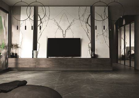 Modern living room where urban and minimal styles meet eachother. The cladding behind the TV cabinet was made using the large-format book match Marble Breach matte porcelain stoneware slabs from the Florim Stone line. In contrast, the Marble Gray matte ceramic flooring.