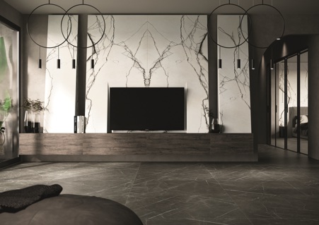 Modern living room where urban and minimal styles meet eachother. The cladding behind the TV cabinet was made using the large-format book match Marble Breach matte porcelain stoneware slabs from the Florim Stone line. In contrast, the Marble Gray matte ceramic flooring.