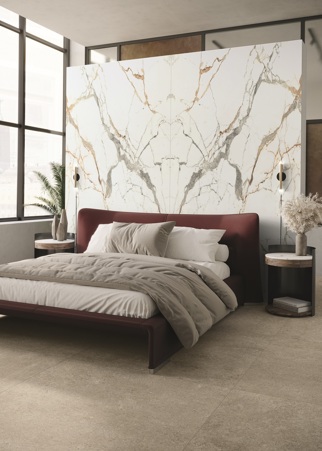 Original bedroom where the rear wall of the headboard has been covered with large-format Eternal Gold matt book match stoneware slabs by the Florim Stone brand. In combination, the shaped nightstand top always in Eternal Gold matte ceramic. For the floor, instead, Fossil Ivory matte stoneware was used, again from the Florim Stone brand.