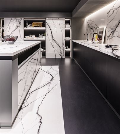 Modern kitchen composed of full height cabinet sliding doors, island doors, island top, kitchen top and back in Marble Breach matte porcelain stoneware.