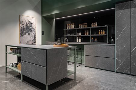 Industrial kitchen with island front and drawers in Marble gray matte stoneware. The shelves, drawers and full-height cabinet doors have also been made in Marble Gray matte stoneware