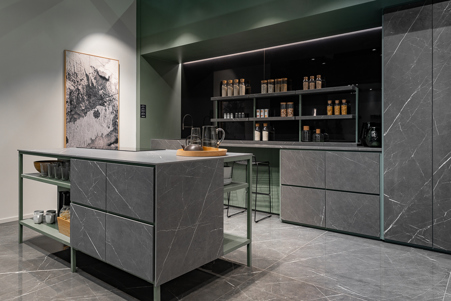 Industrial kitchen with island front and drawers in Marble gray matte stoneware. The shelves, drawers and full-height cabinet doors have also been made in Marble Gray matte stoneware