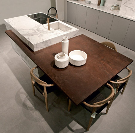 Kitchen island consisting of a part of the storage counter used as a worktop and assembled sink completely covered in glossy Marble Statuario and snack top in Russet matte Metal stoneware